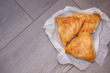 Indian, Asian food delicious samsa or samoses on wooden background. Top view, flat lay. Copy space.
