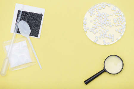Concept of kids experiments. Flat lay magnifier glass, papers, spoon on yellow background. Copy space.の写真素材