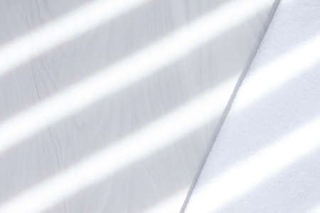 Clean white towel on white background with sunlight. Comfort and clean concept.の写真素材