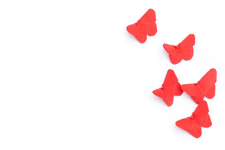 Red origami paper butterflies on white background.の写真素材