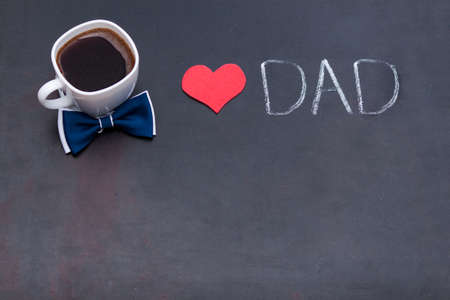 Cup of black coffee for father, hearts on black background. I love you DAD concept. Flat lay, copy space.の写真素材