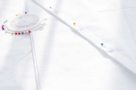 Tailoring, sewing tools, accessories on white cloth. Copy space.の写真素材