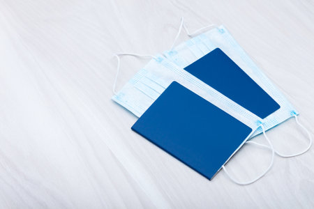 Medical surgical masks lying in passport. Rules for or after quarantine, vacations 2020 concept.の写真素材