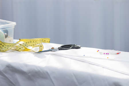 Tailoring, sewing tools, accessories on white cloth. Copy space. Consept stay at home, work at home.の写真素材