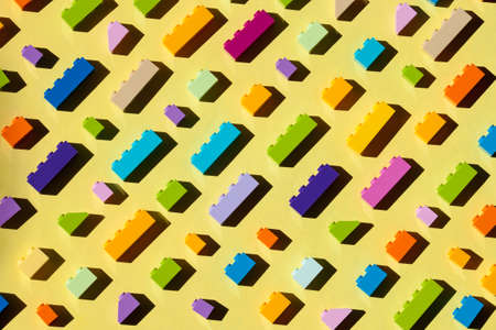 Colorful plastic brickes background with sun light. Building bussines concept.の写真素材