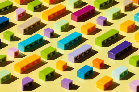 Colorful plastic brickes background with sun light. Building bussines concept.