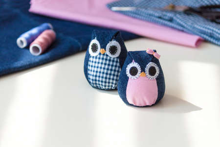 Hand made owls. Craft tools and materials on the table.の写真素材