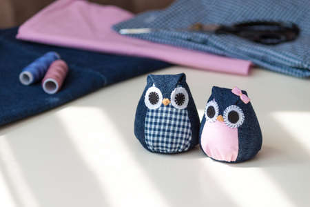 Hand made owls. Craft tools and materials on the table.の写真素材