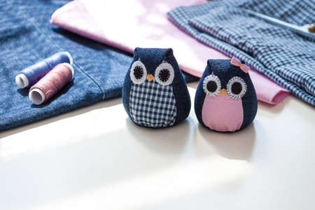 Hand made owls. Craft tools and materials on the table.の写真素材