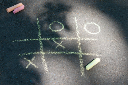 Tic-tac-toe chalk game on asphalt, drawing on the sidewalk.の写真素材