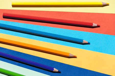 Color pencils on colored background. Back to school, arrangement concept.