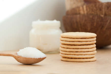Bowl with coconut oil and cookies on wooden backgroundの写真素材