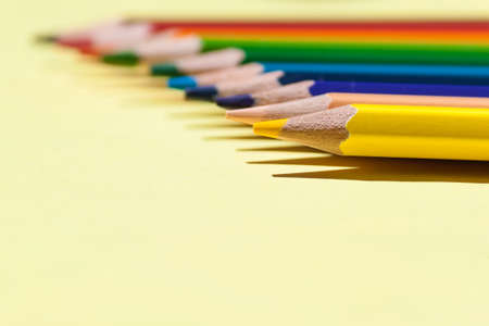 Color pencils on colored background. Back to school, arrangement concept.