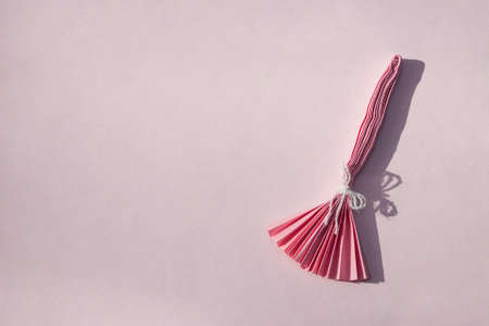 Pink paper witchcraft on pink background. Halloween creative background with copy space.の写真素材