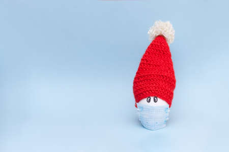 Egg with Santa hat. Creative minimal christmas concept.の写真素材