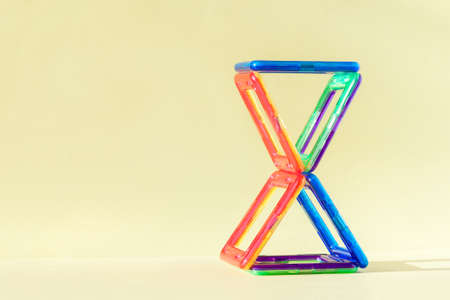 Colorful magnetic building blocks on pastel backgroundの写真素材