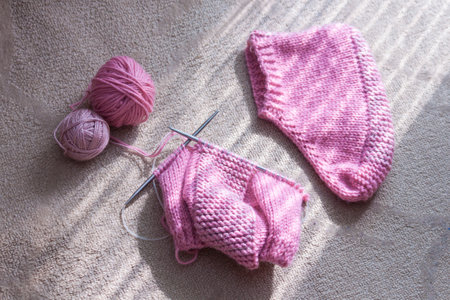 Pink knitted socks. Hobby relax concept.