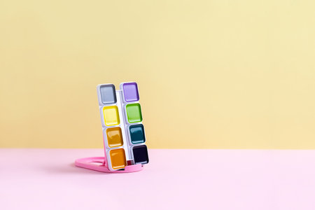 Palette of color paints on pink yellow background. Minimal art concept.の写真素材