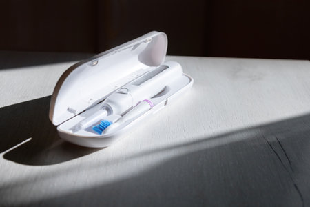 electrical white toothbrush in white case.の写真素材
