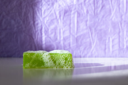 Green hygiene soap with foam, copy space.の写真素材