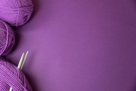Background with knitting tools and accesories, colorful purple skein yarn, hobby concept, copyspaceの写真素材