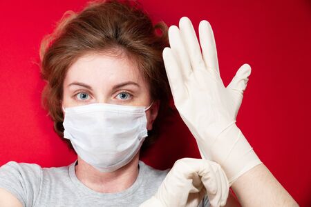 Stop the virus and epidemic diseases. Healthy woman in blue medical protective mask showing gesture stop. Health protection and prevention during flu and infectious outbreakの写真素材