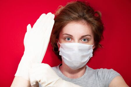 Stop the virus and epidemic diseases. Healthy woman in blue medical protective mask showing gesture stop. Health protection and prevention during flu and infectious outbreakの写真素材