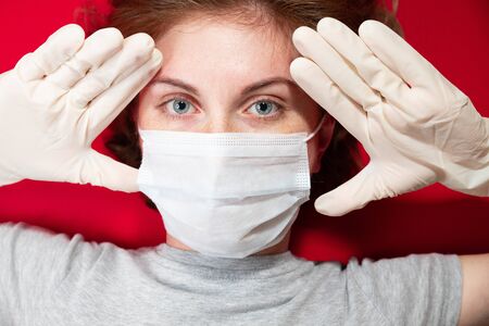 Stop the virus and epidemic diseases. Healthy woman in blue medical protective mask showing gesture stop. Health protection and prevention during flu and infectious outbreakの写真素材