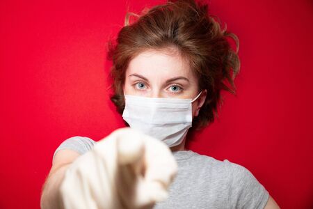 Stop the virus and epidemic diseases. Healthy woman in blue medical protective mask showing gesture stop. Health protection and prevention during flu and infectious outbreakの写真素材