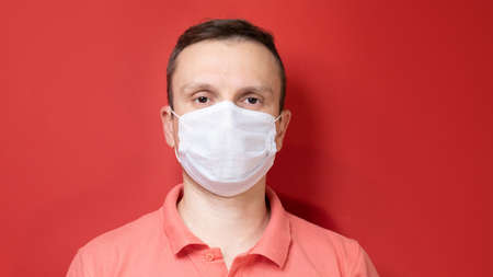 Portrait of a man with a surgical maskの写真素材