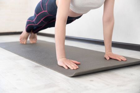Young sporty woman practicing yoga lessonの写真素材