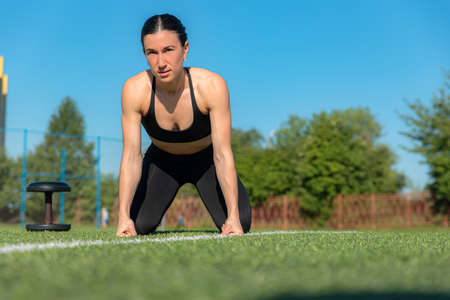 Fitness sport girl in fashion sportswear doing yoga fitness exercise in the street, outdoor sports, urban styleの写真素材
