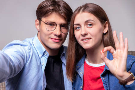 Happy young people communicate with relatives and friends via webcam. The concept of video conferencing. Teleconference.Bloggers and teachers sit in their home office, looking at the camera.の写真素材