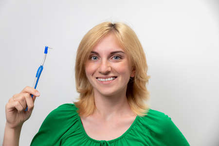 Portrait of a beautiful woman with braces on her teeth, isolated on a white background. The concept of the perfect smileの写真素材