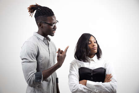 African american couple quarrelling sorting out relationship on white studio background. Guy blaming offended womanの写真素材