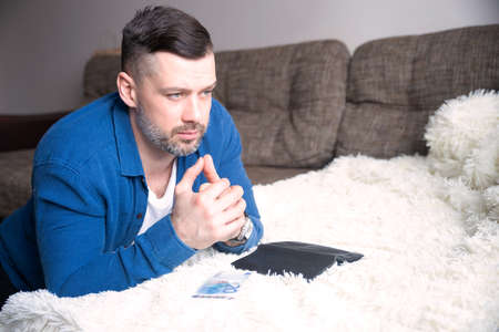 Young guy with last euros money, wallet think how to earn. Male experiencing financial difficulties, planning budgetの写真素材