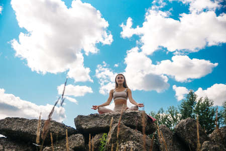 Lifestyle woman yoga exercise and pose for healthy life. Young girl or people pose balance body vital zen meditation for workout nature mountain background in morning sunrise with mat outdoor banner.の写真素材