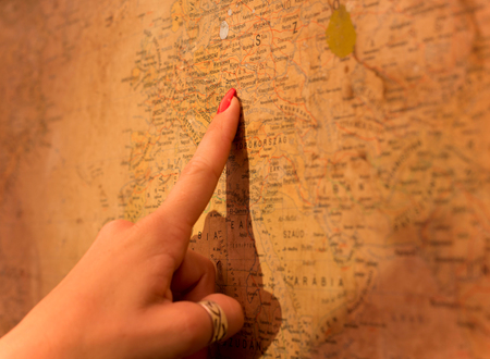 Girls hand shows at the map