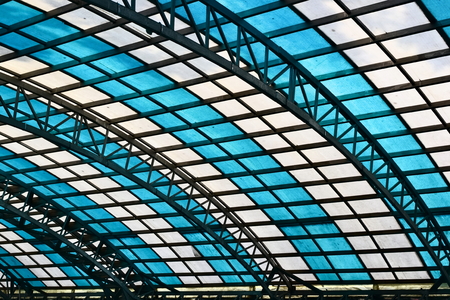 Glass roof with white and blue window cells in the waiting hall of Sarai Rohilla railway station,...