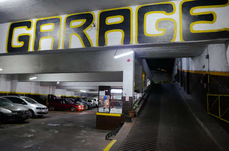 Buenos Aires, Argentina - January, 2020: Underground parking lot with big letters name Garage. Car...