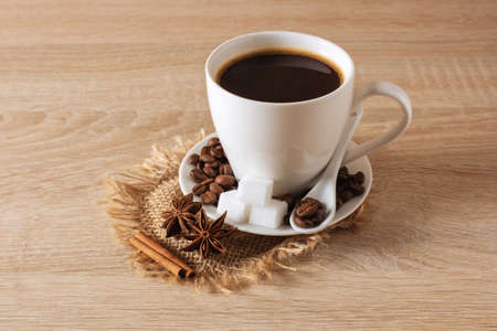 white cup of coffee, coffee beans, cinnamon, aniseの写真素材