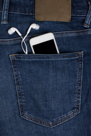 Mobile phone headphones pocket jeans fashion musicの写真素材