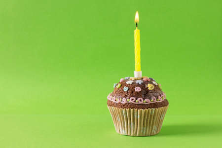 homemade muffin, cupcake with candle on a green backgroundの写真素材