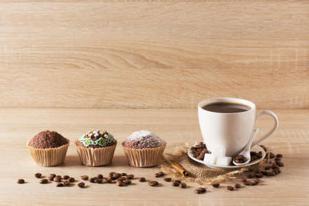 Muffins and a cup of coffee on a light backgroundの写真素材