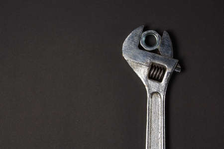 wrench and screw nut on a black backgroundの写真素材