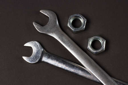 Two spanners and screw-nuts on black backgroundの写真素材