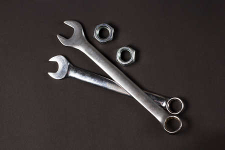 Two spanners and screw-nuts on black backgroundの写真素材