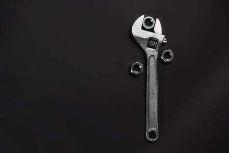 wrench and screw nuts on a dark backgroundの写真素材