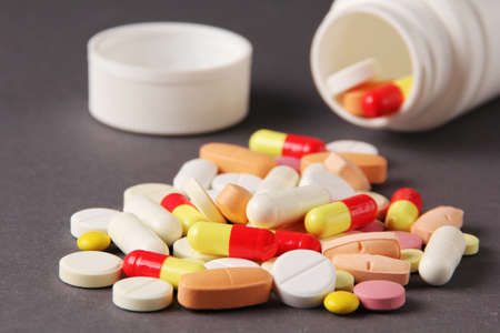 pills, vitamins, capsules on a gray backgroundの写真素材