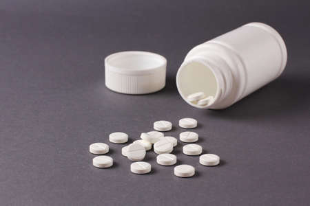 a lot of pills on a gray backgroundの写真素材